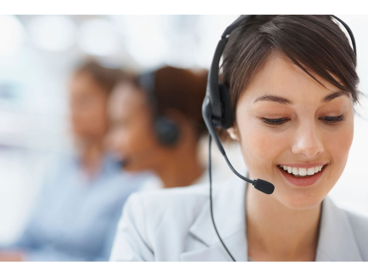 Smiling call center employee during a telephone conversation