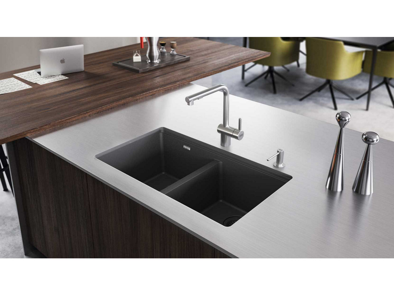 Modern Franke Slate Grey double-bowl granite kitchen sink with sleek stainless steel faucet and soap dispenser, set in a contemporary kitchen featuring metallic accessories and a wooden countertop.