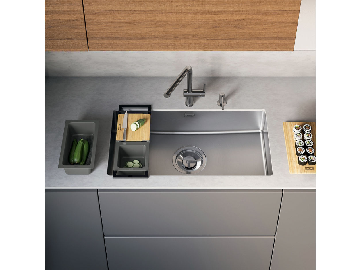 Modern Franke stainless steel kitchen sink with a stainless steel tap and accessories