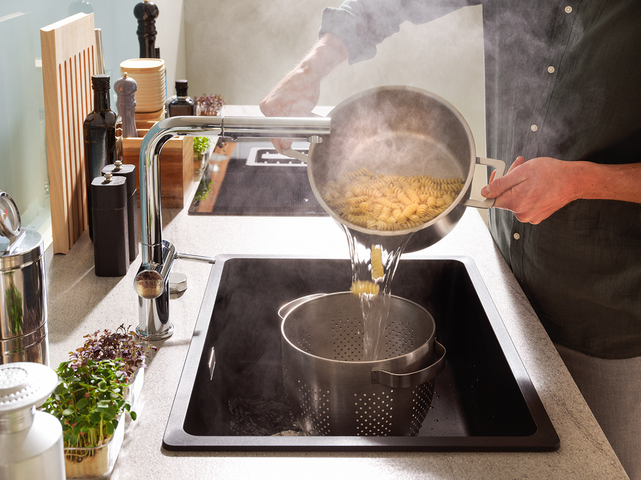 Pasta being poured in pot inside a Maris Bowl sink
