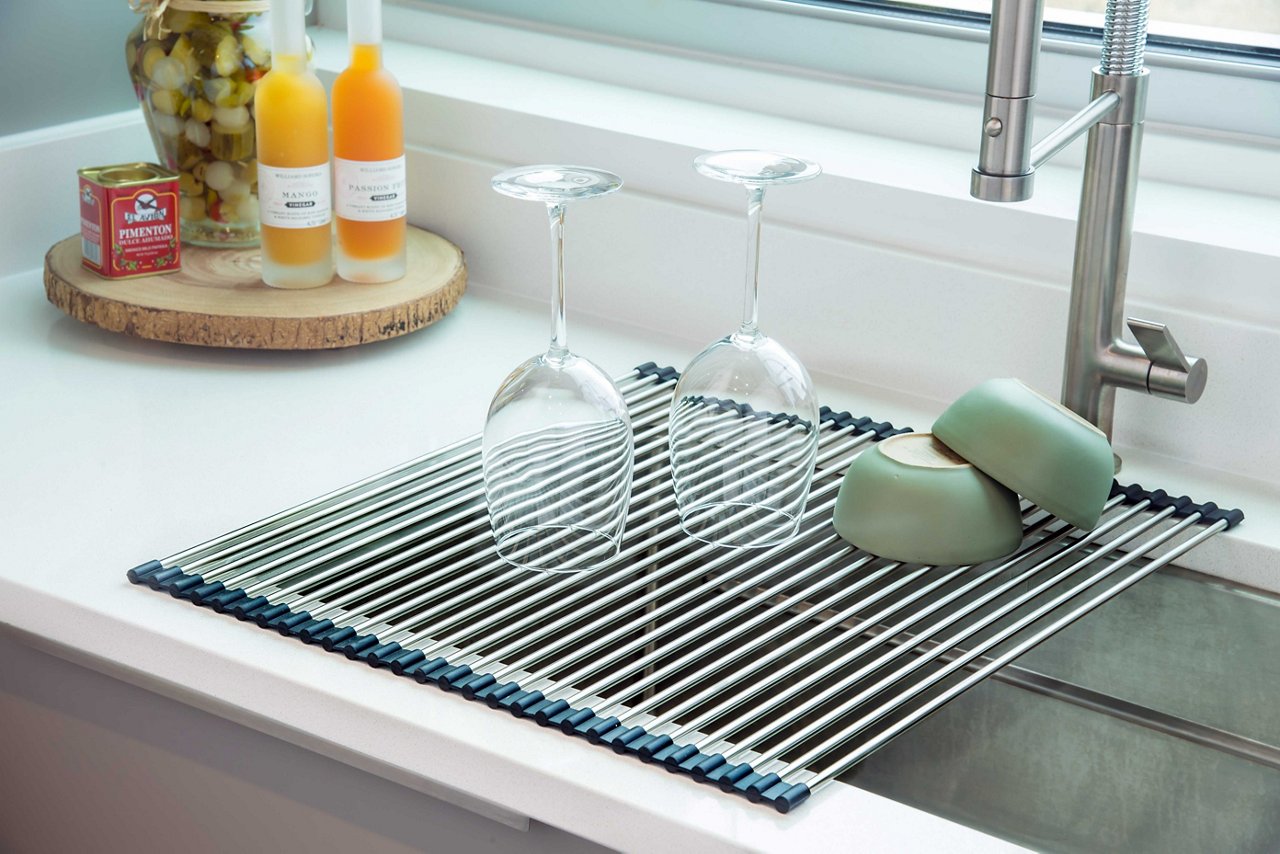 Dishes drying on a Franke roller mat over a kitchen sink