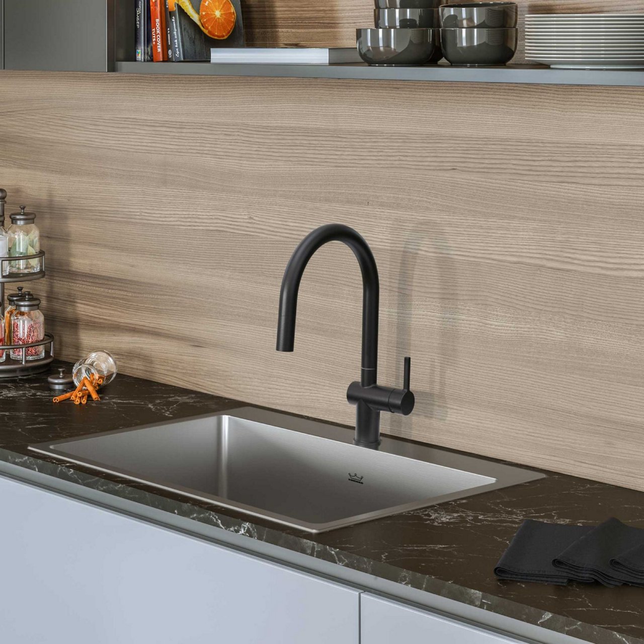 Kitchen featuring a drop in single bowl stainless steel kitchen sink with a matte black faucet