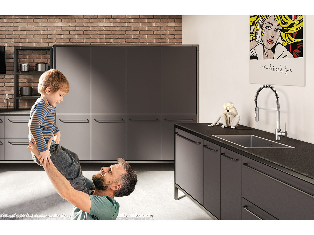 cheesy moment between son and dad on kitchen floor