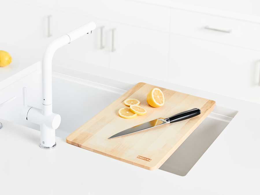 kitchen sink cutting board with lemons being sliced