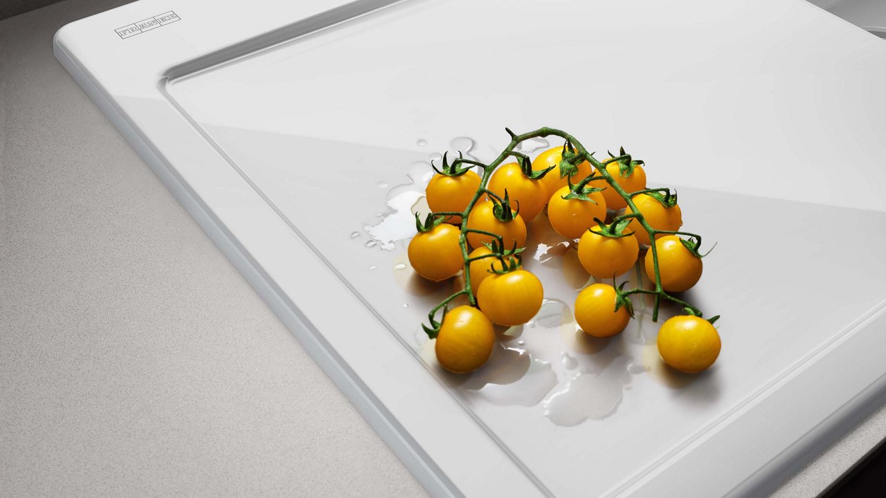 A white ceramic Franke kitchen sink with elegant finishing, a view of the bowl with a drain.