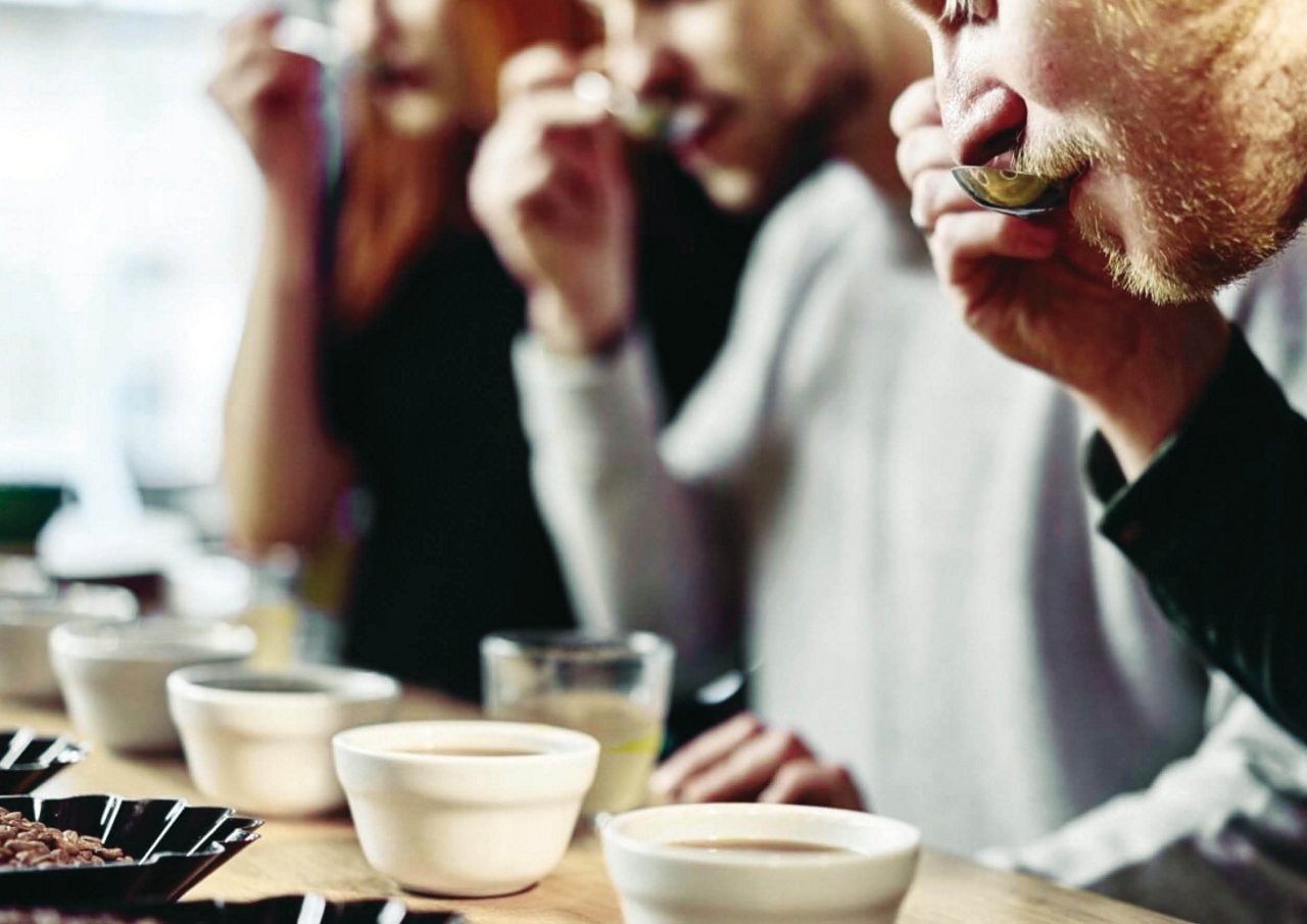 Franke Coffee Systems people tasting espresso with spoon, cups, beans