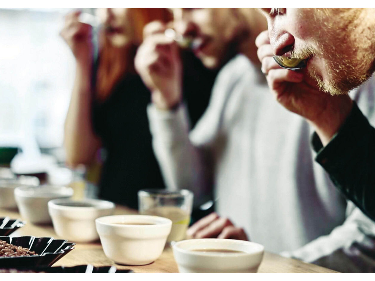 Franke Coffee Systems people tasting espresso with spoon, cups, beans