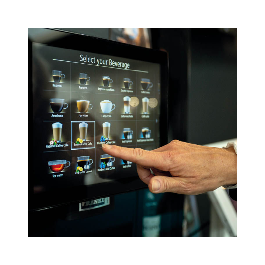 Franke Coffee Systems, fully automatic coffee machine Franke, touchscreen with beverage menu, hand selecting beverage