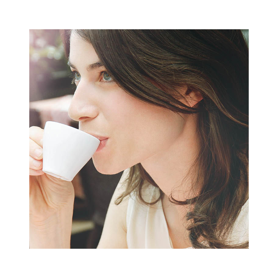 Franke Coffee Systems woman drinking espresso, white cup