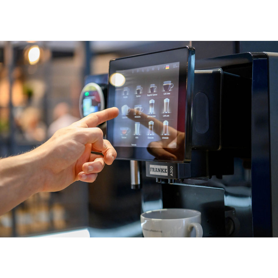 Franke Coffee Systems hand on the coffee machine screen ordering a drink,  fully automatic coffee machine Franke A300