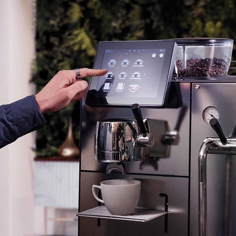 Franke Coffee Systems, Mytico, BeyondTraditional fully automatic and hybrid coffee machine, touchscreen, barista selecting beverage