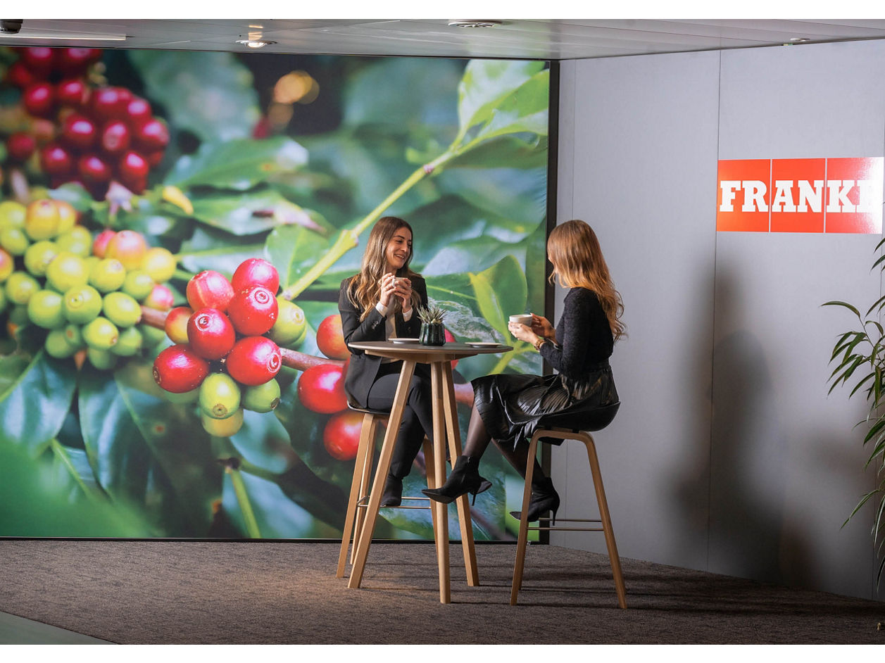 Franke Coffee Systems, Aarburg, Showroom, two women sitting on high table chatting and drinking coffee