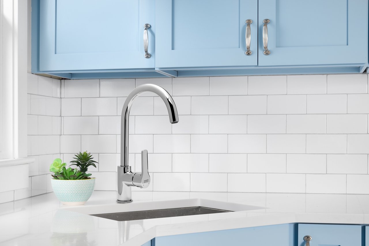 Chrome highrise mixer in a white and light blue kitchen