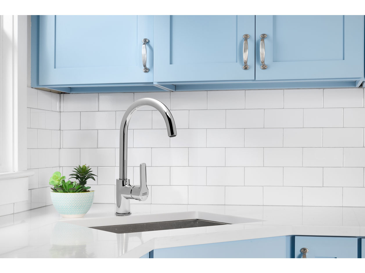 pescara professional mixer installed over a black sink on an ornately tiled spanish kitchen countertop