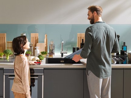 Adult and child cooking together