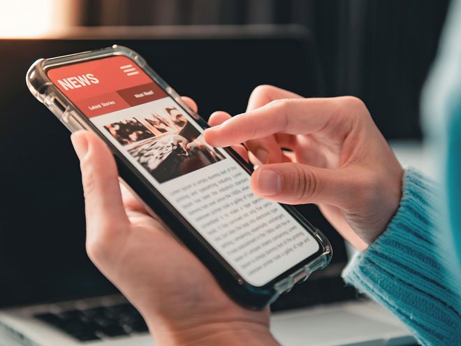 person reading news on a mobile device