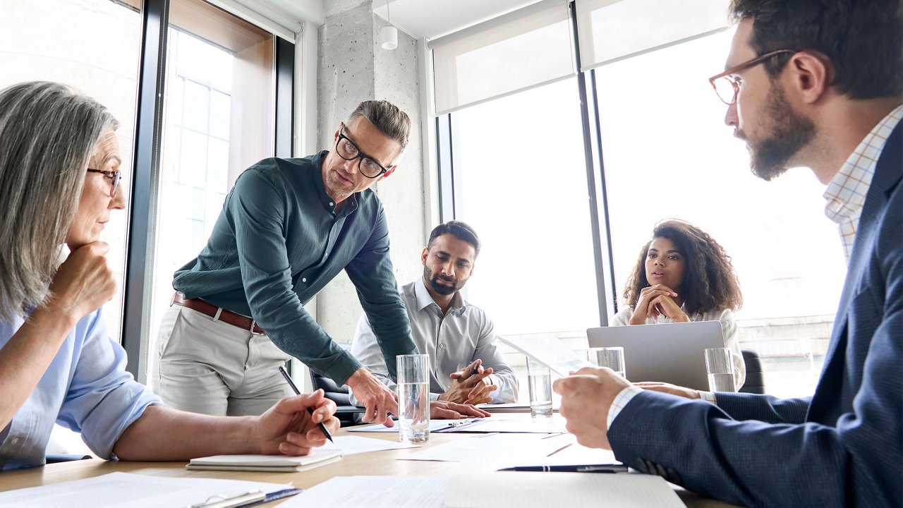 Group of 5 people working in a office