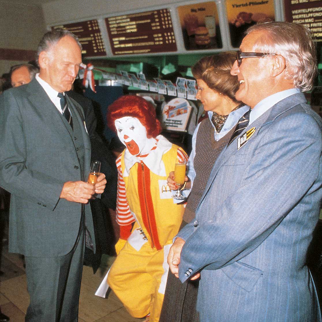 The Clown Ronald McDonald surrounded by people 