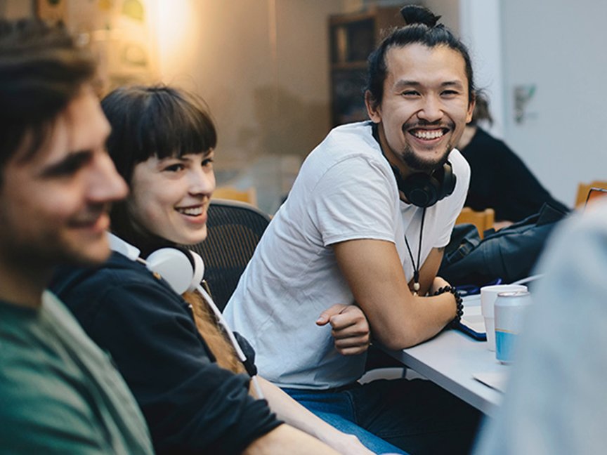 three young people listening