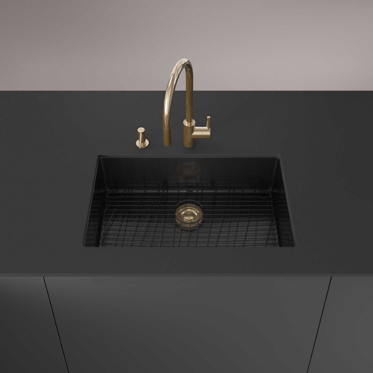 Kitchen island featuring a Mythos Masterpiece undermount kitchen sink in Anthracite paired with a gold Eos Neo faucet and matching soap dispenser.