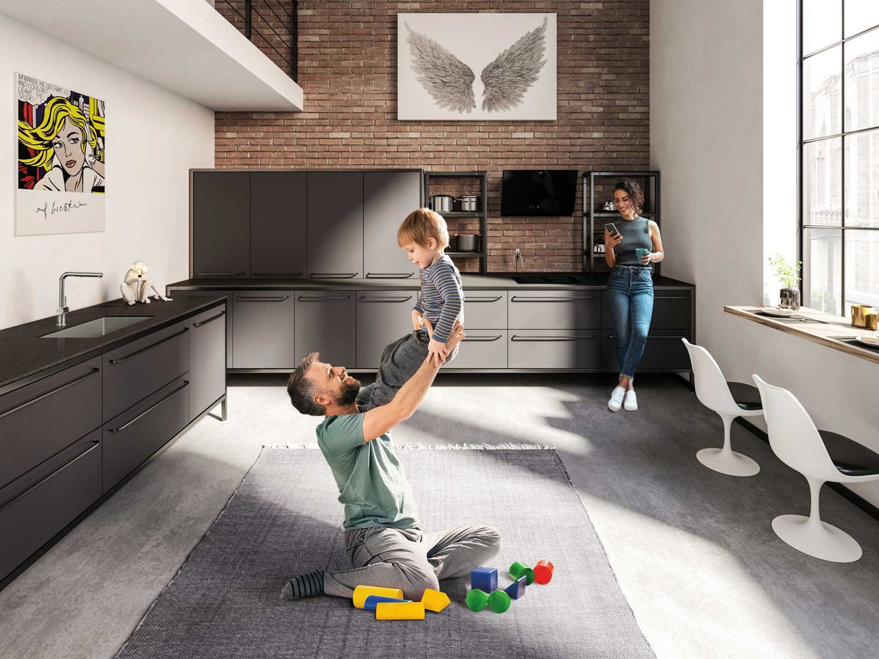 Modern loft kitchen with a man playing with a young child on the kitchen floor