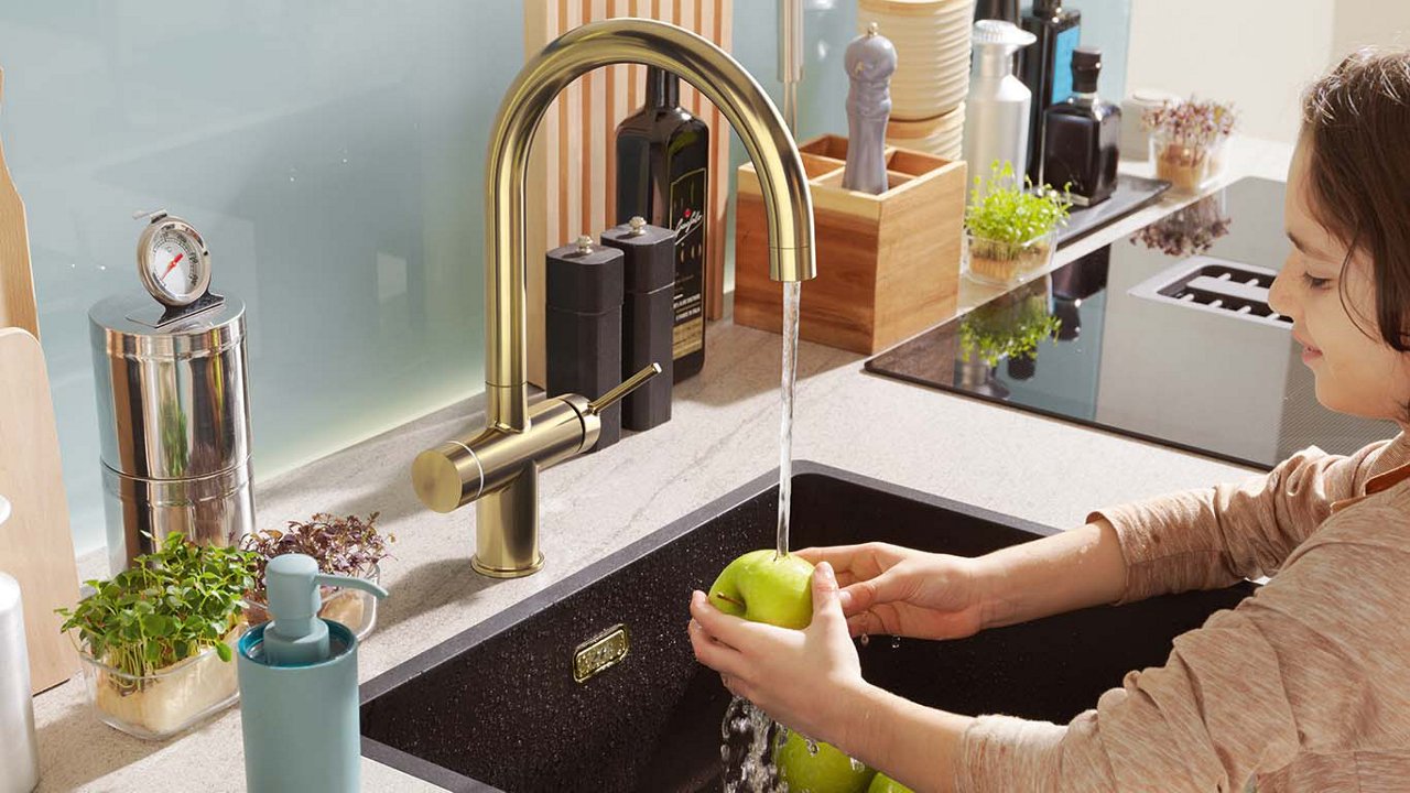 Boy washing an apple using Franke tap