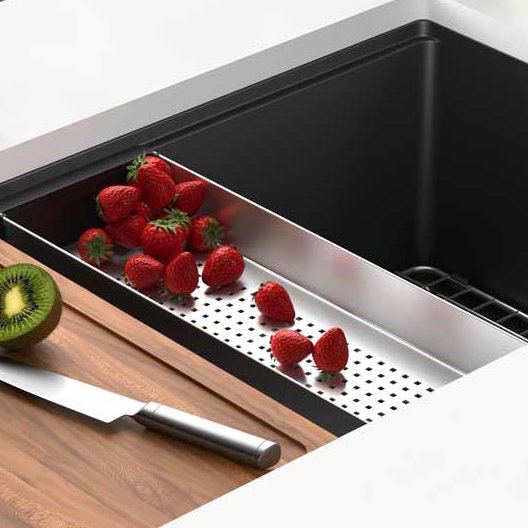 Vegetables being prepped in a Franke Maris matte black granite kitchen sink 