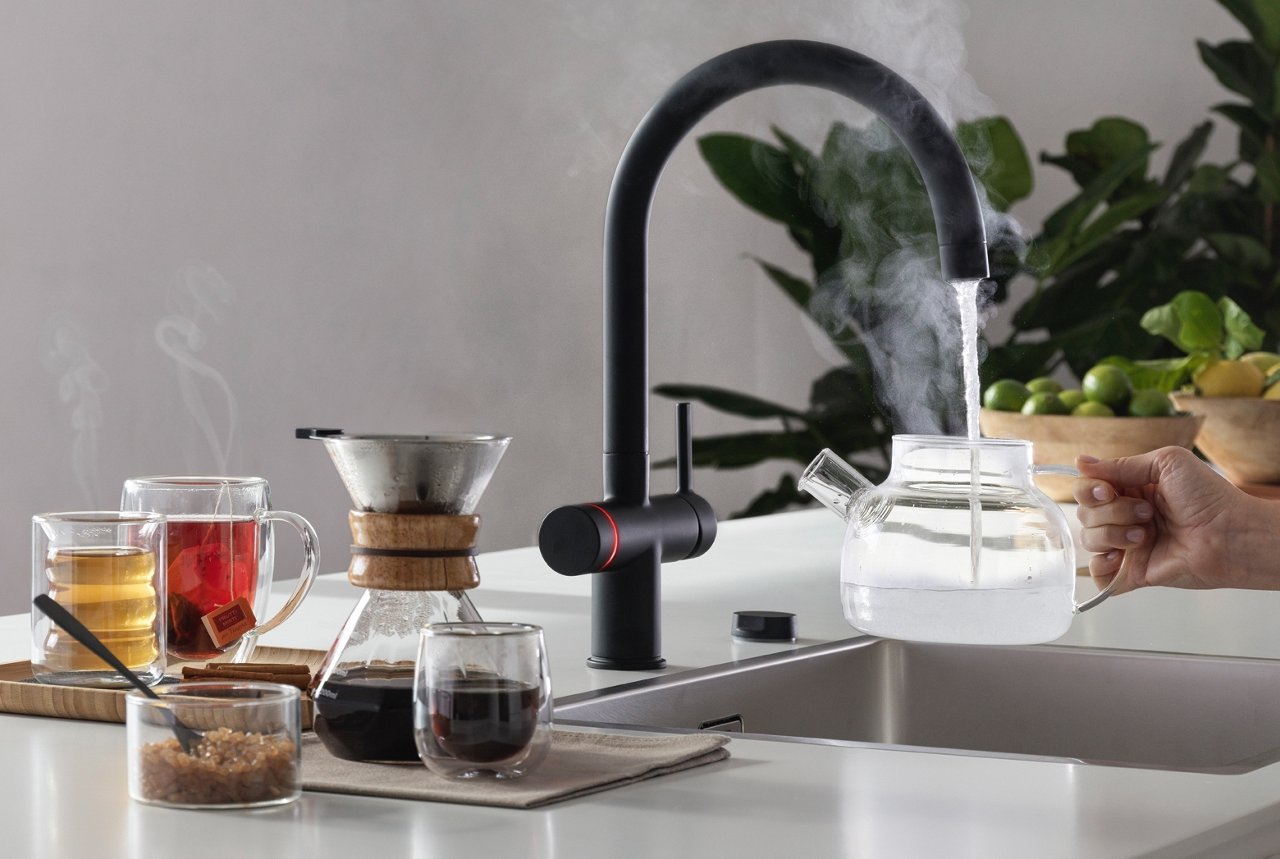Maris Water Hub tap dispensing boiling water into a glass teapot