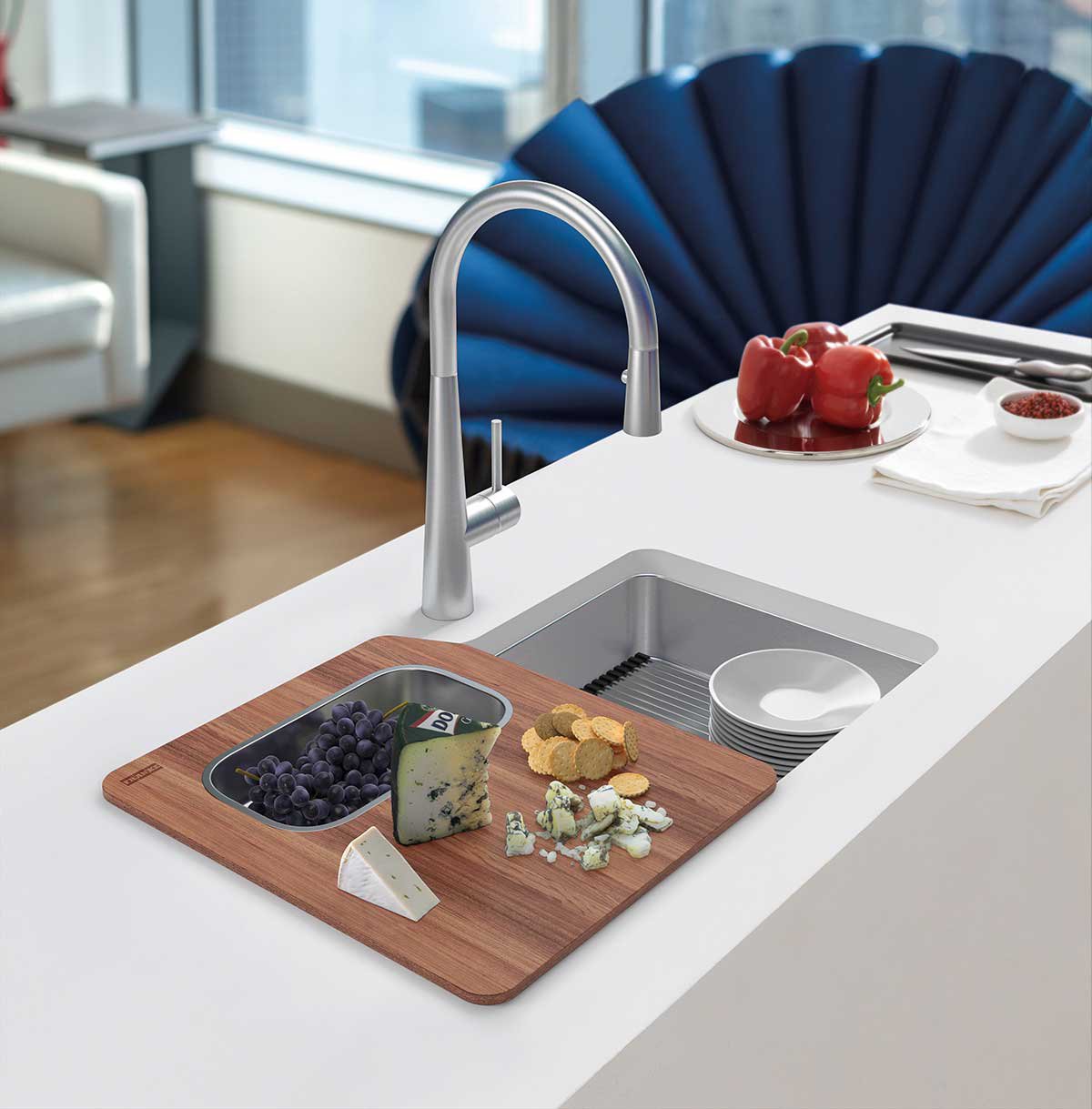 Single bowl stainless steel kitchen sink with over sink cutting board and shelf roller mat in a large kitchen island
