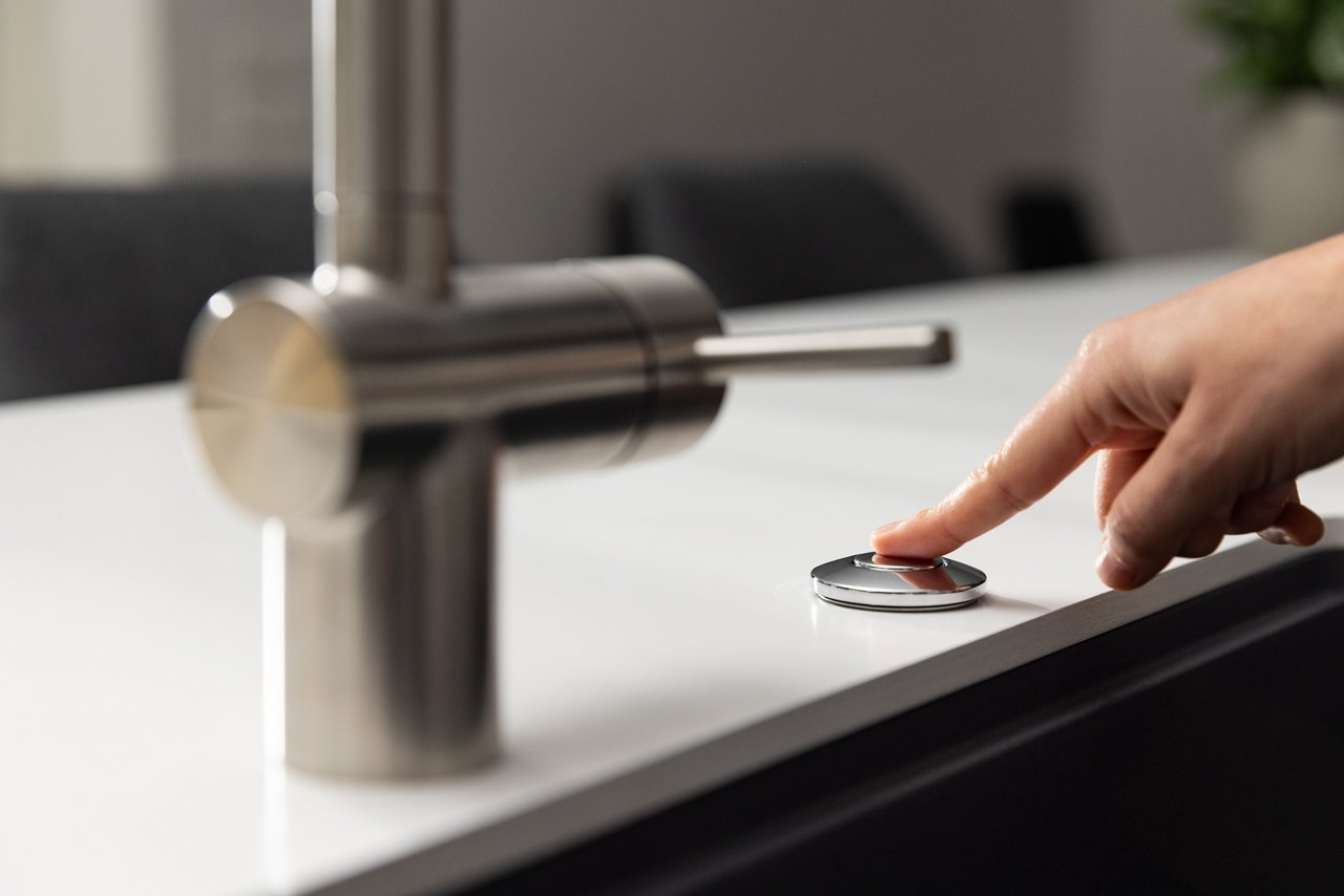 Pushing the Air Switch Button to activate a Food Waste Disposer