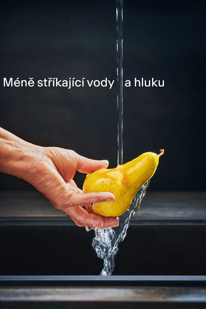 Man Holding a pear under a laminar jet to showcase the splash reduction effect