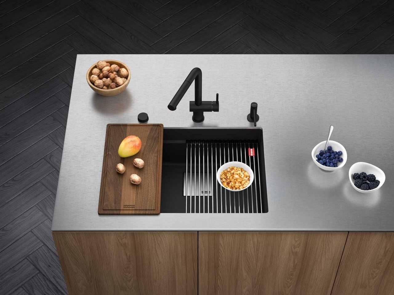 Peak matte black workcenter granite kitchen sink in a kitchen island with a stainless steel countertop 