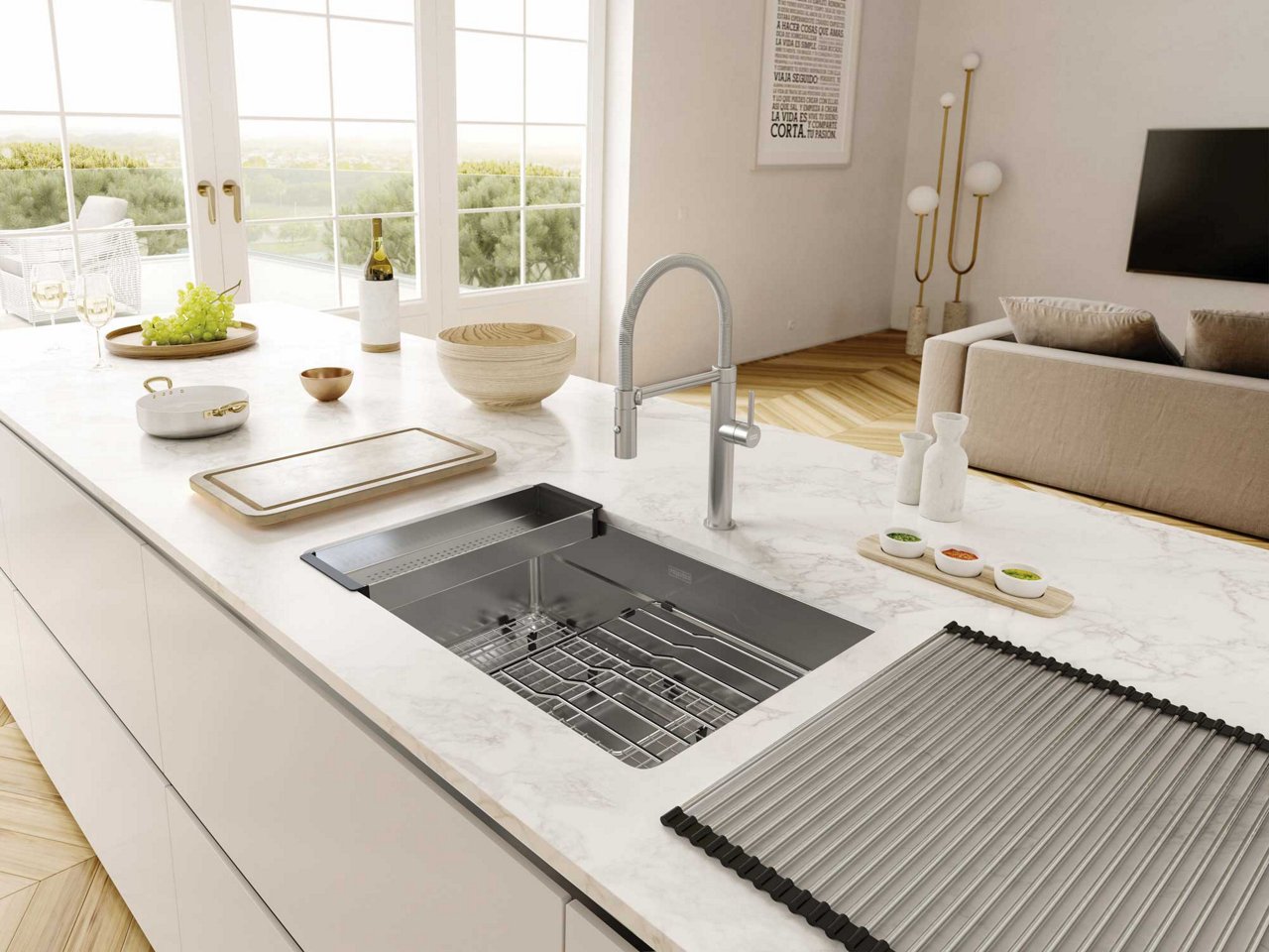 Bright modern kitchen with a large island featuring a Franke pescara stainless steel undermount workstation sink paired with a  Pescara Semi Pro faucet