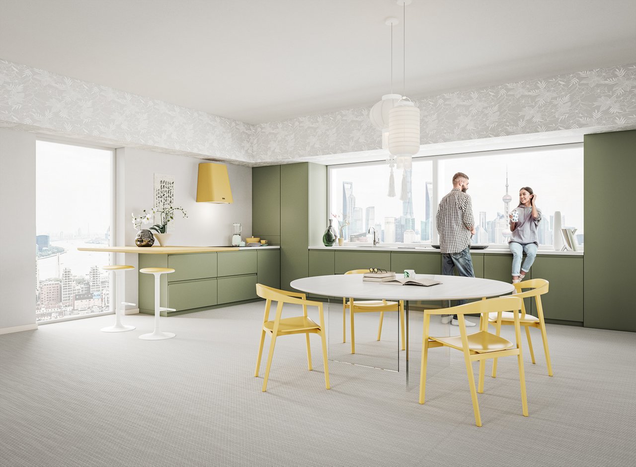 couple chat in the yellow/ green kitchen of their highrise apartment 