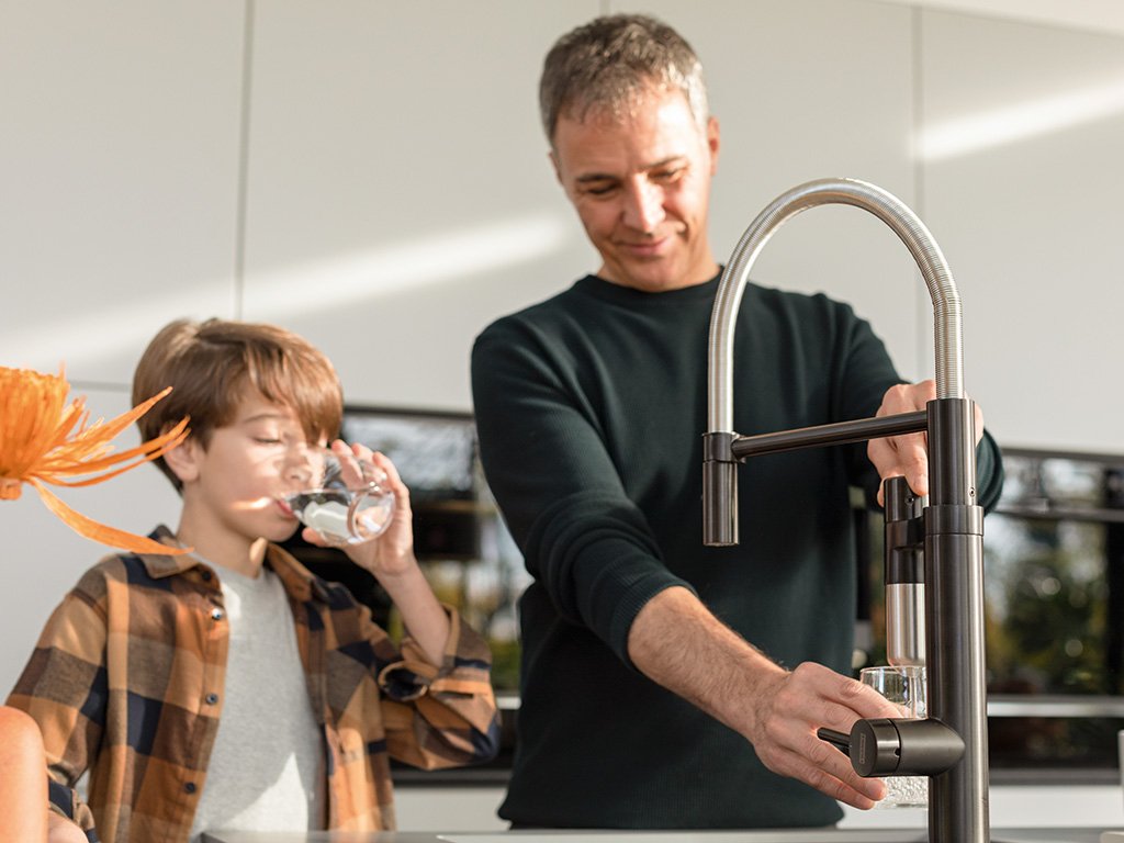 Father and son using Franke Vital kitchen tap