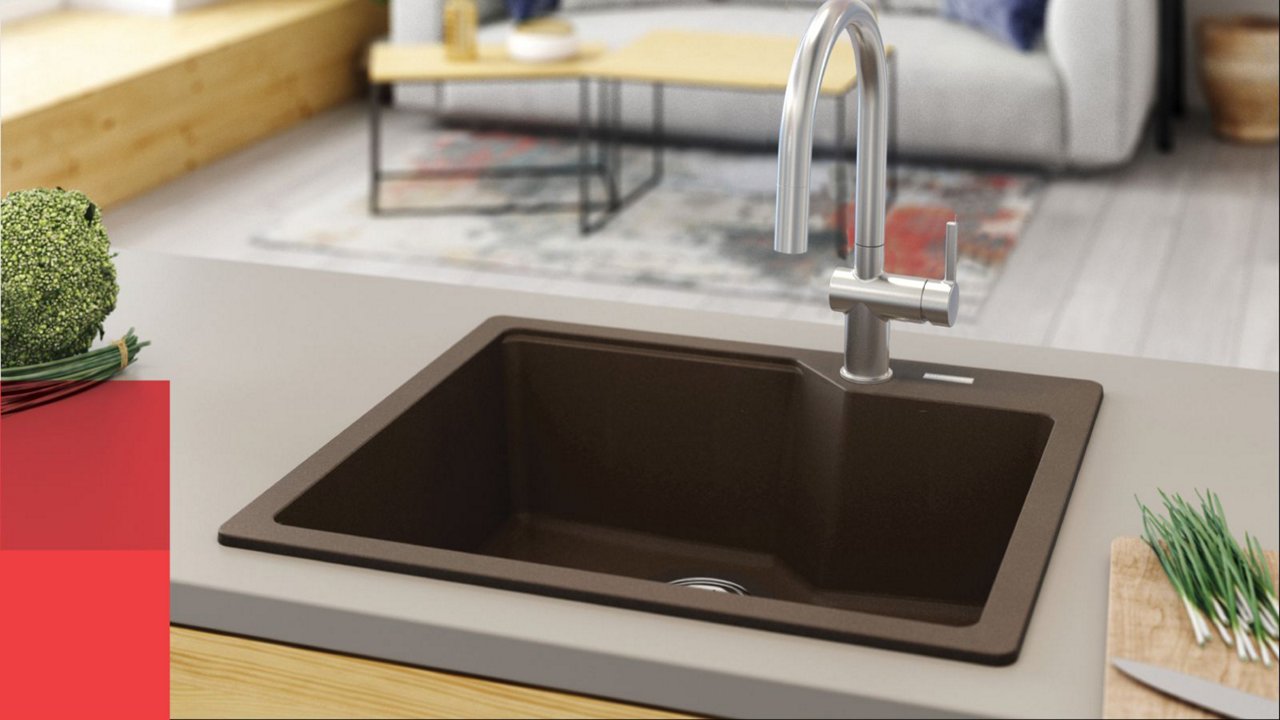 Kindred Mocha granite single bowl drop in granite sink with a chrome faucet in a kitchen island with a grey countertop 