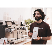 Franke Coffee Systems, Schibello Coffee, Mytico, Matt Annetta, barista man talking in front of the coffee machine and holding a coffee bag