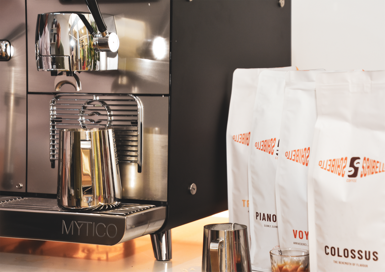 Franke Coffee Systems, Schibello Coffee, Mytico coffee machine close-up, spout, milk jug, coffee packages