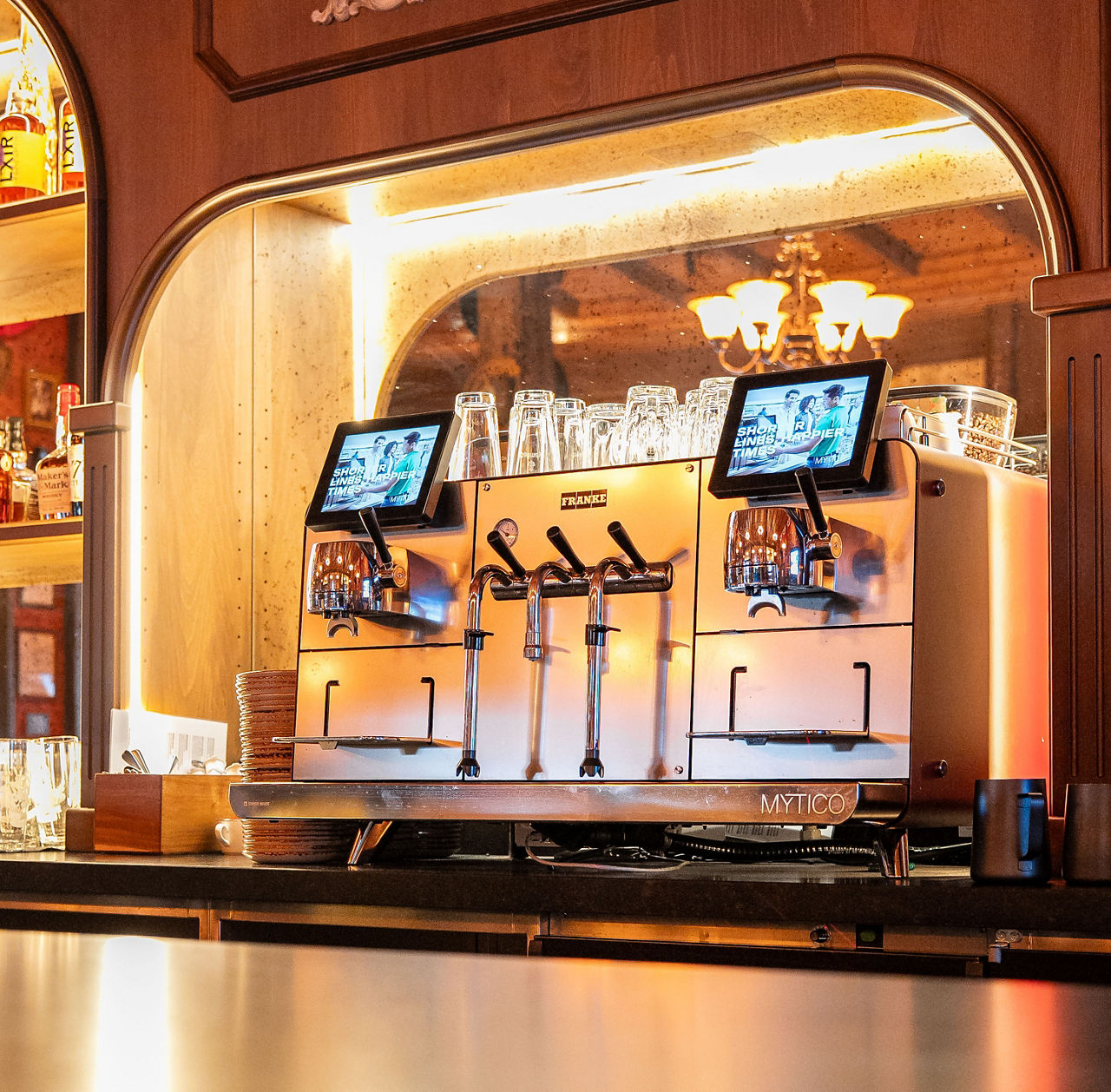 Close-up of the Franke Mytico coffee machine, featuring a modern design and integrated beverage outlet.