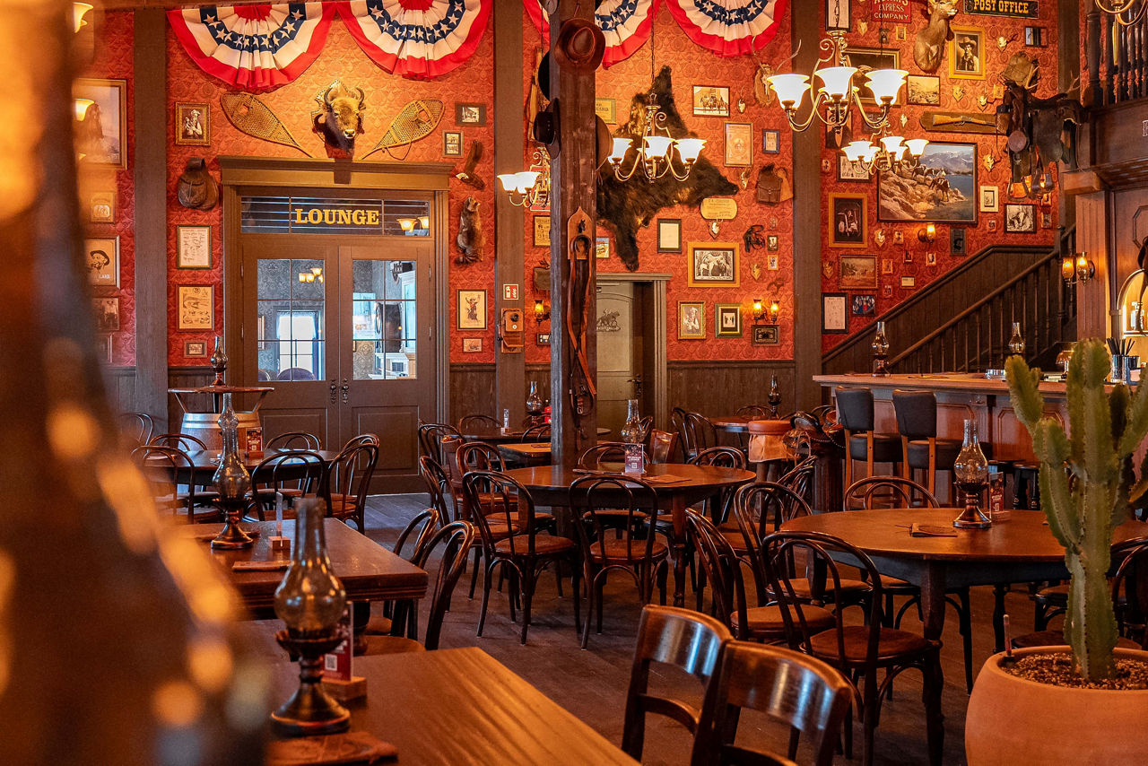 Interior view of the Wild Horse Bar at Europa-Park, featuring a Western-style atmosphere, seating, and bar area.
