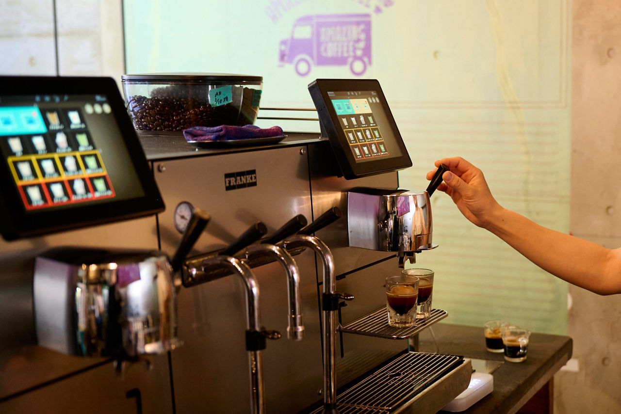 Close-up of a barista operating the Franke Mytico