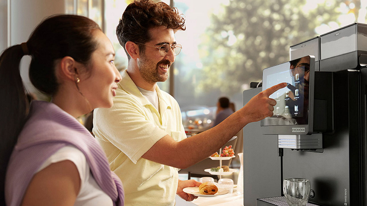 Franke Coffee Systems, guests in the breakfast area of a hotel, ordering a drink from the New A Line coffee machine, fully automatic coffee machine
