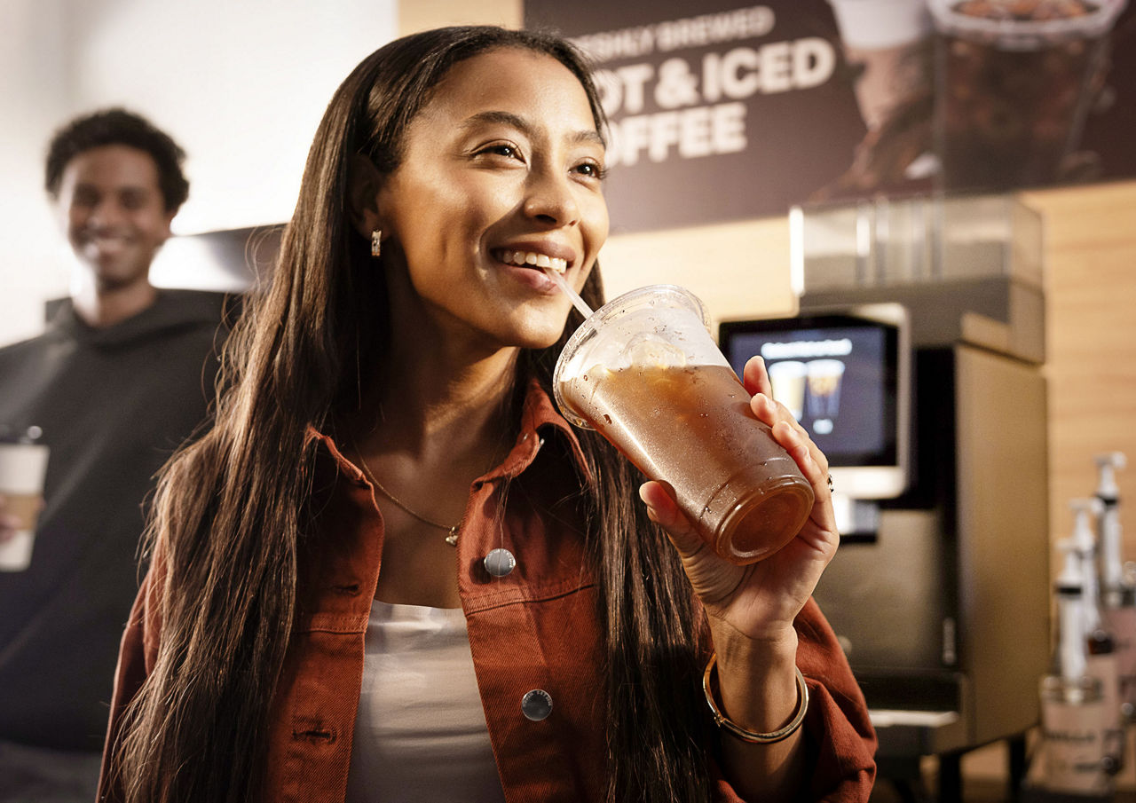 Woman drinking iced coffee