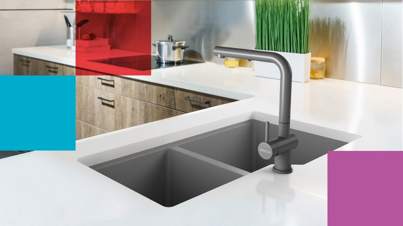 Kindred double bowl drop in grey granite sink  with matching grey faucet in a modern kitchen with white countertops