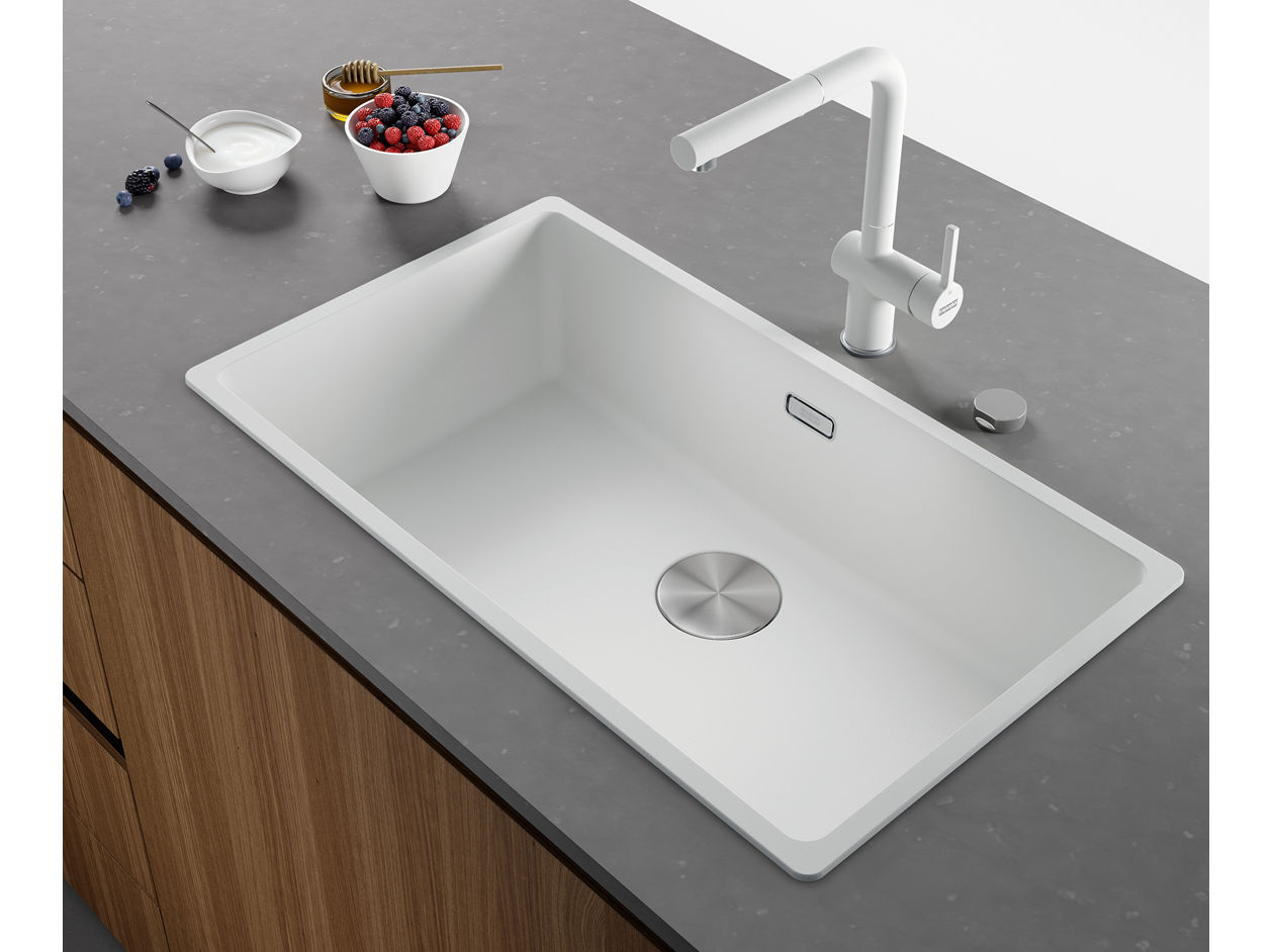 Raised view of a white kitchen sink and mixer