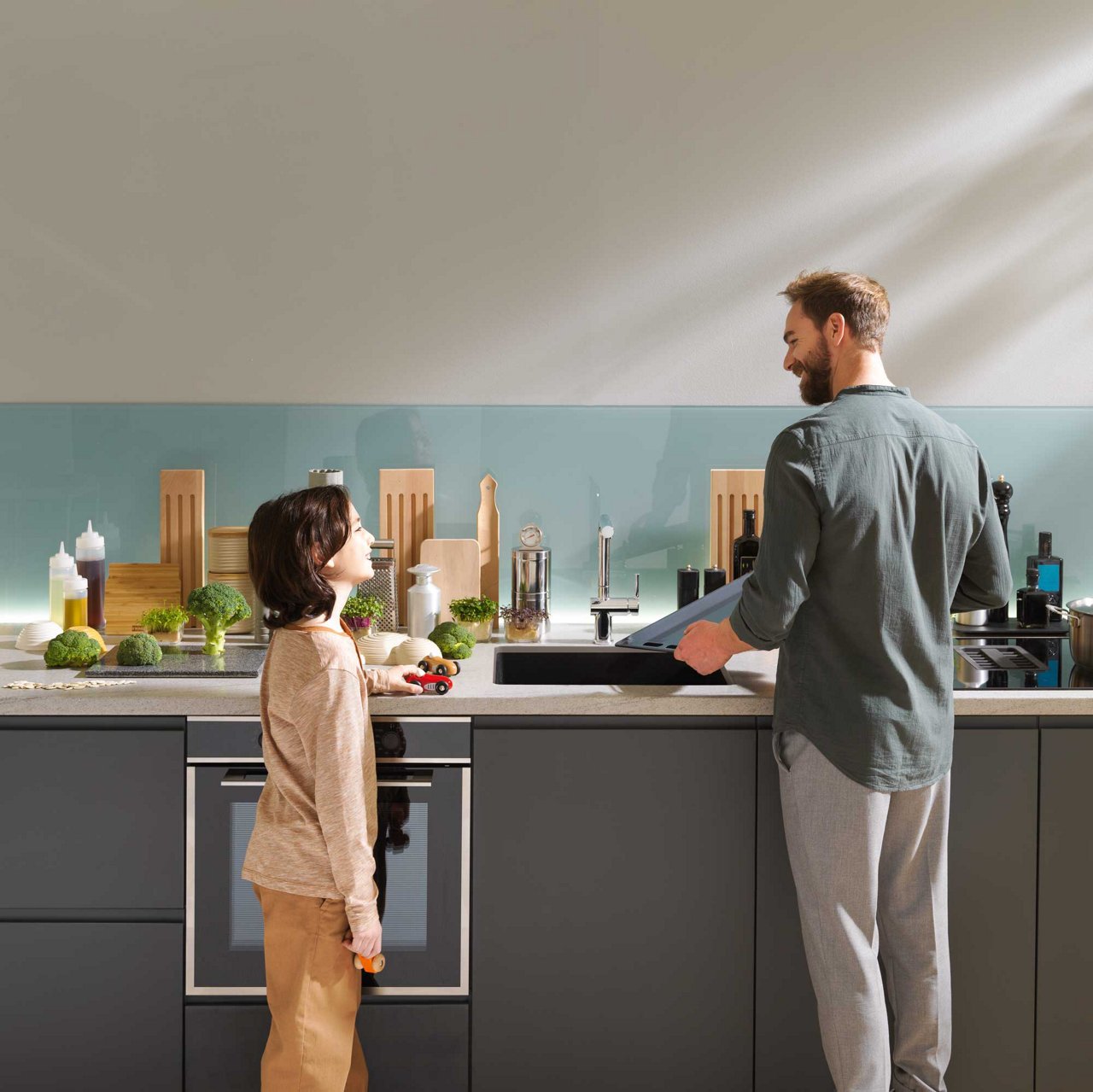 Father and son washing dishes in a Franke Maris undermount sink