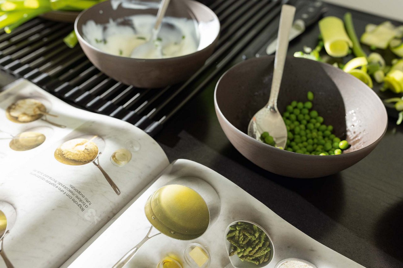 Cooking ingredients and a cookbook on a kitchen counter