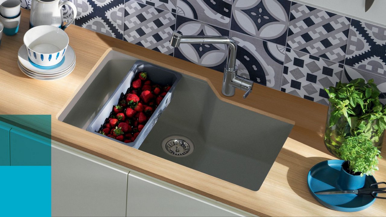 Kindred single bowl grey granite undermount kitchen sink in a butcher block counter top with a chrome kitchen faucet