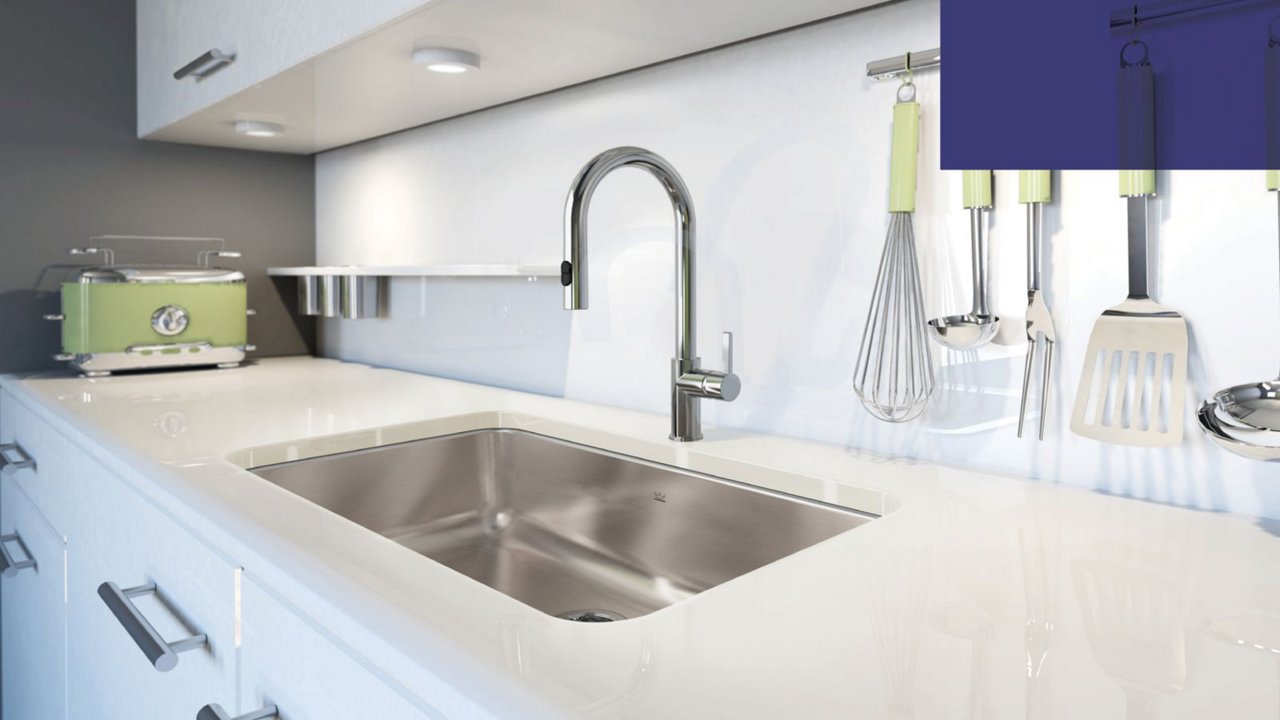 Single bowl undermount kitchen sink and chrome faucet in a moden white kitchen with lime green accents