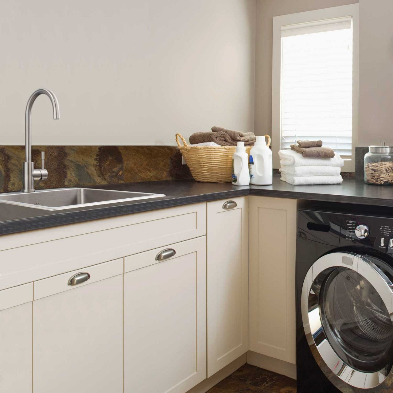 Kindred single bowl stainless steel deep capacity sink in a beige laundry room